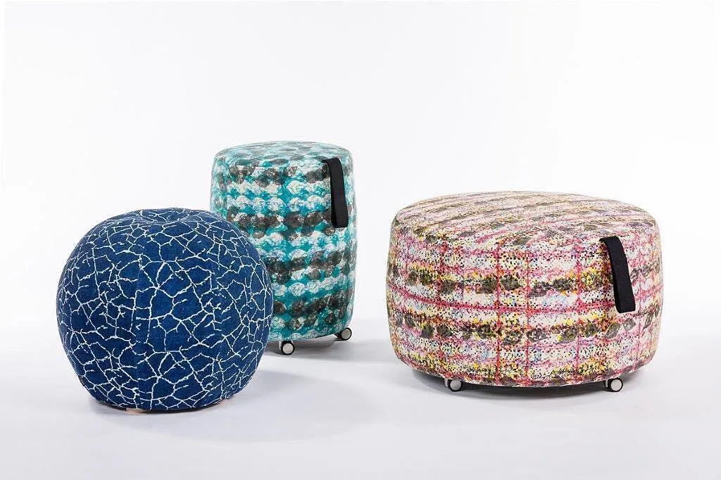 Cracked-earth blue print upholstered on ottomans