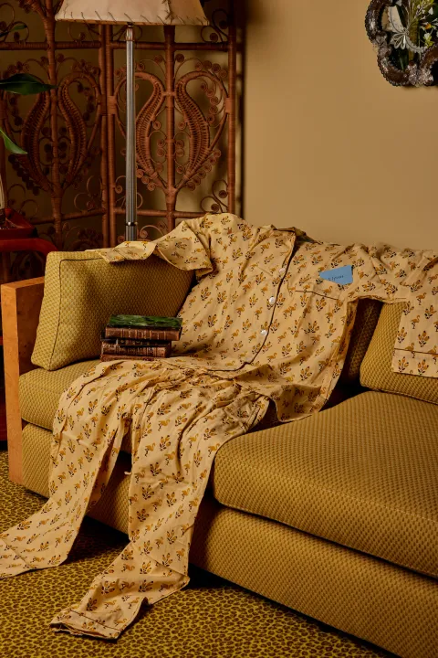 Ulysses flamingo-print pyjamas draped over a sofa
